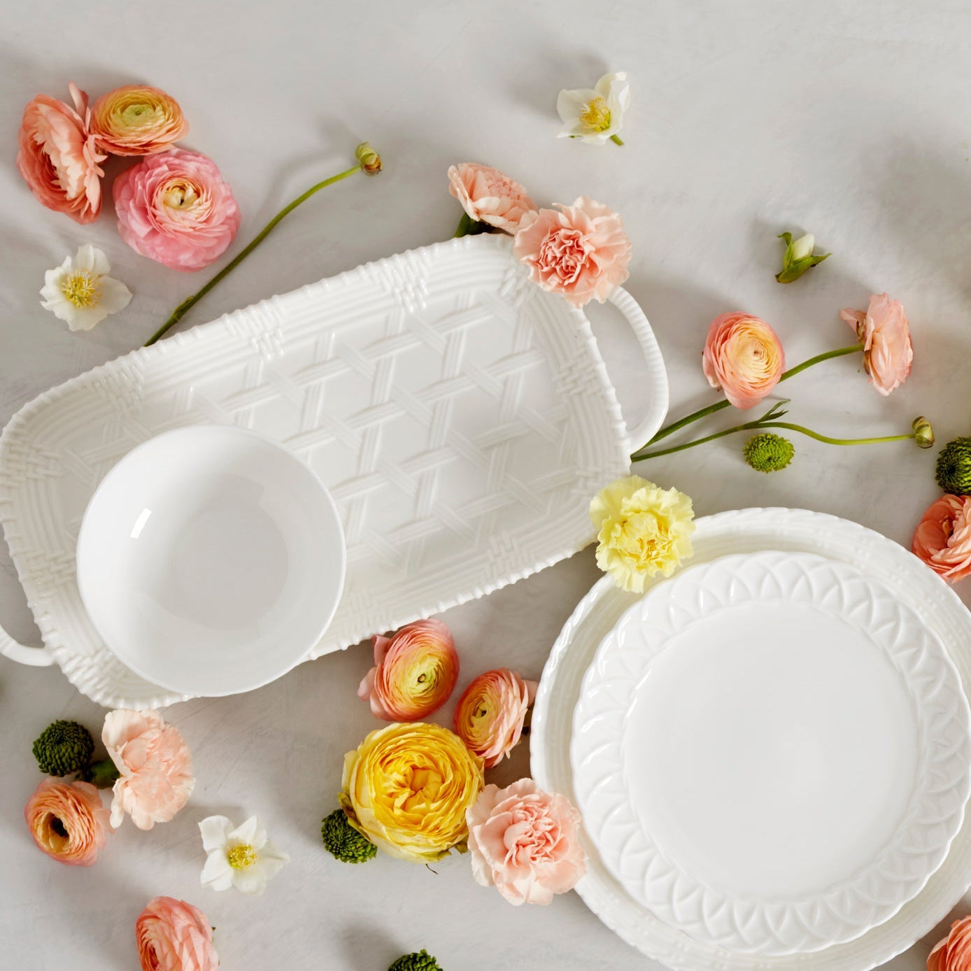 White ceramic dishes with floral decorations on a light background