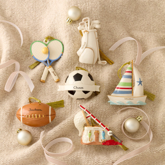 Collection of sports-themed Christmas ornaments on a textured surface